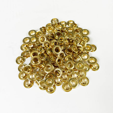 Pile of gold colored brass grommets