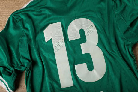 Green sports jersey with the number 13 on the back in white heat transfer vinyl