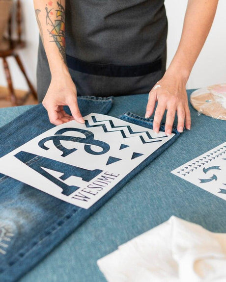 Woman doing crafts on jeans with stencil film