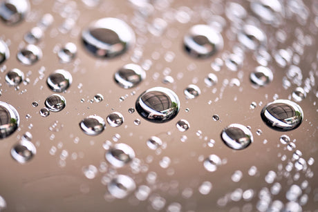 Water droplets falling off of a vinyl clear coat