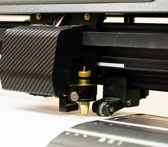 Close up on vinyl cutter blade cutting