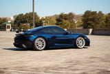 KPMF K75000 Series Premium Iridescent Wrapping Cast Vinyl Blue Black Iridescent wrapped sports car on a track with trees and buildings in the background