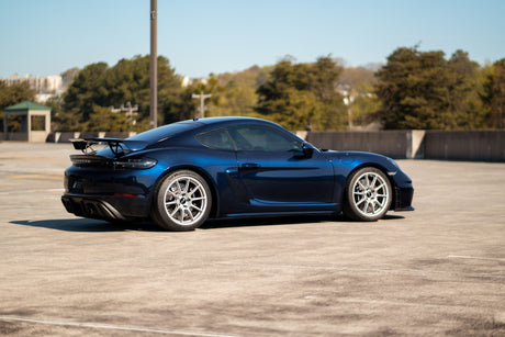 KPMF K75000 Series Premium Iridescent Wrapping Cast Vinyl Blue Black Iridescent wrapped sports car on a track with trees and buildings in the background