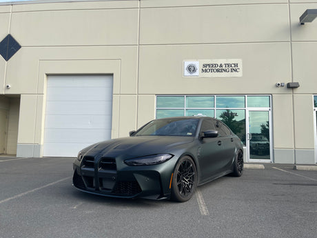 KPMF K75000 Series Premium Iridescent Wrapping Cast Vinyl Matte Platinum Dark Sage wrapped BMW car parked in front of a building with 'Speed & Tech Motoring Inc.' sign.