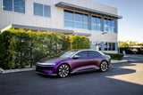 KPMF K75000 Series Premium Iridescent Wrapping Cast Vinyl  Purple Black Iridescent wrapped electric car parked in front of a modern building with greenery.