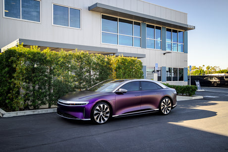 KPMF K75000 Series Premium Iridescent Wrapping Cast Vinyl  Purple Black Iridescent wrapped electric car parked in front of a modern building with greenery.